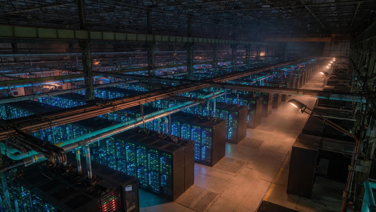 Endless rows of server racks with cyan status lights in an industrial supercomputer hall.