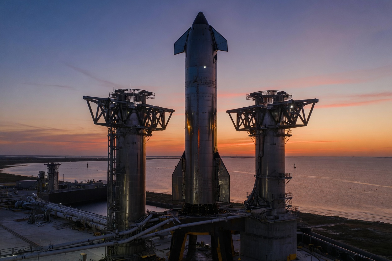 Stainless-steel Starship on a catch tower on the Gulf Coast at dusk.